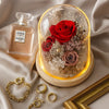 Red rose in a glass dome on a beige fabric background
