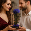 Couple holding a blue rose under a glass dome
