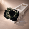 Bouquet of black preserved rose and greenery in a white box