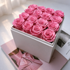 White box filled with pink preserved roses